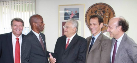 The Minister meeting with other gentlemen in suits. Shaking hands with one.