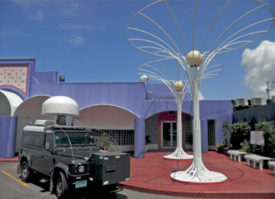 Spectrum Management Authority Jamaica. A vehicle, with some communication equipment mounted on it, sits in a parking lot.