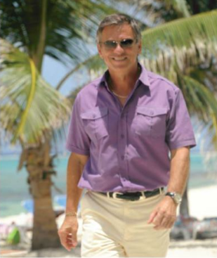 Gaetan Babin, Director of Wyndham Reef Resort walking along the beach.