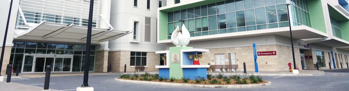 Bermuda Hospital Board. Outside view of a hospital showing emergency sign on the corner of the building.