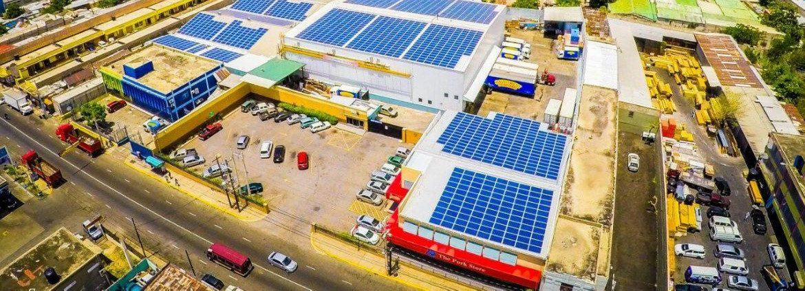 Sofos Jamaica, aerial view of multiple rooftops with solar panels.