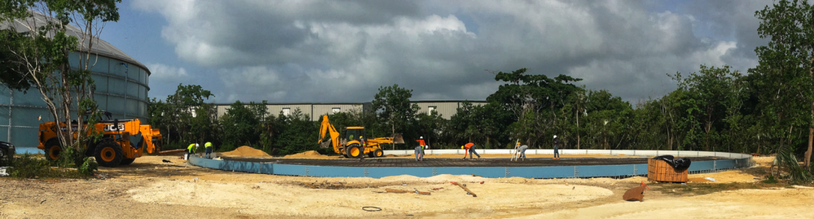 A water authority Cayman construction site with excavators and employees at work.
