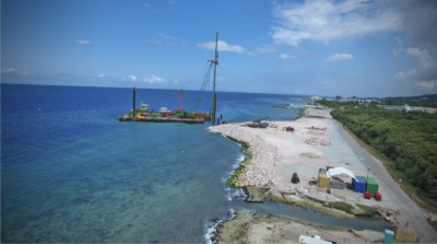 CWM Infrastructure. View of a beach from the air, showing a barge working along the beach.
