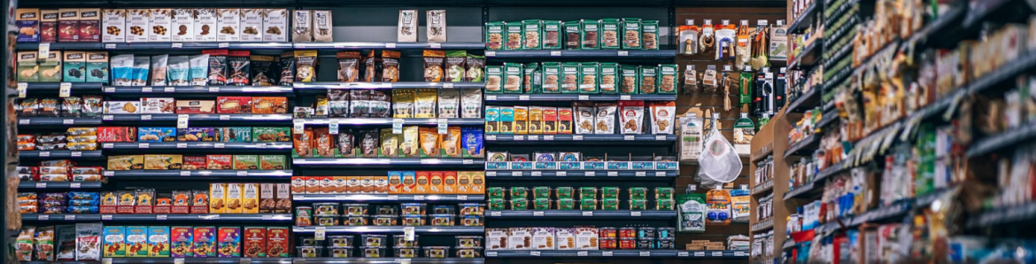 Mangusa Supermarkets shelving fully stocked with food.
