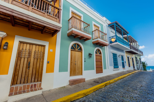 Property Management Inc. Puerto Rico. Colorfully painted houses along a stone paved street.