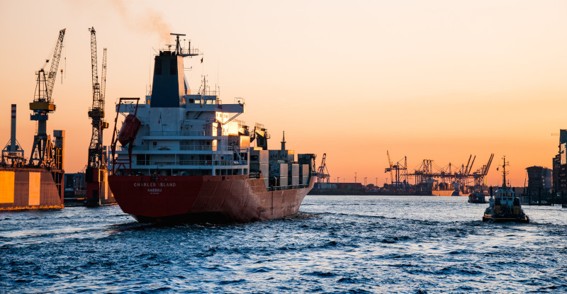 The Anguilla Air and Sea Port Authority; Cargo ship with loading cranes near.