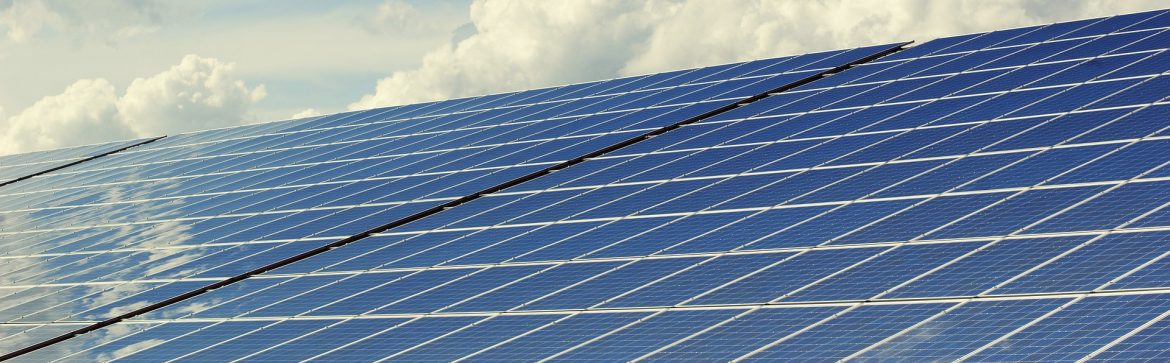 Solar panels with clouds behind.