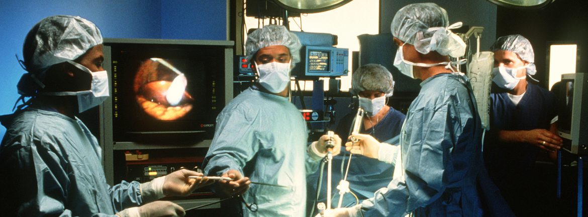 Multiple health professionals performing a procedure on someone in a medical facility. Jamaica Will Need 98,000 Health and Education Professionals by 2040
