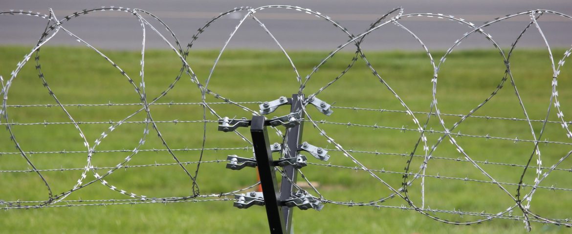 A fence with razor wire on top. New Study Shows how Trinidad and Tobago can Prevent Crimes with Innovative Approach