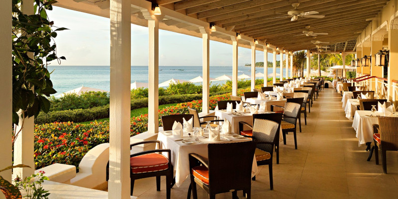 Fairmont Royal Pavillion outside dining table overlooking the beach.