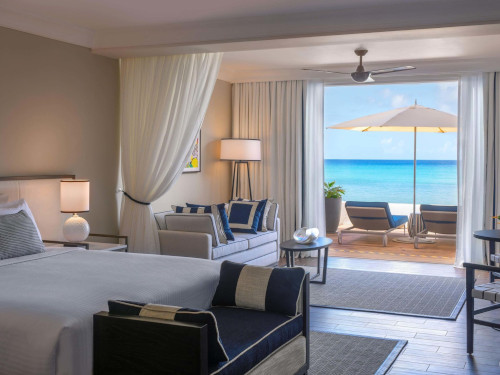 Fairmont Royal Pavillion interior room with a balcony and beach scene beyond.
