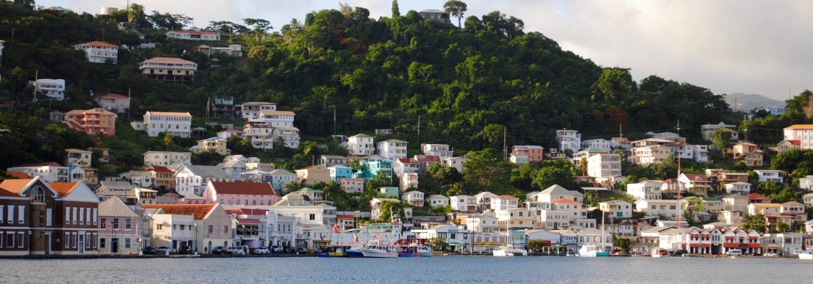 Island of Grenada from the water looking at houses along the shore.