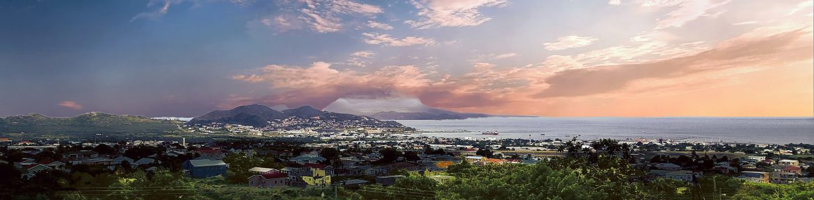 Island of St. Kitts from a distance with a pretty sky on the horizon. Regional Transporation discussed in the article.