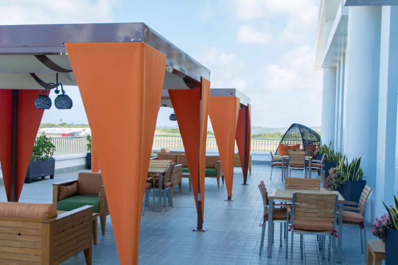 VC Bird International Airport manage by Antigua and Barbuda Airport Authority. Outdoor sitting area overlooking the airport.
