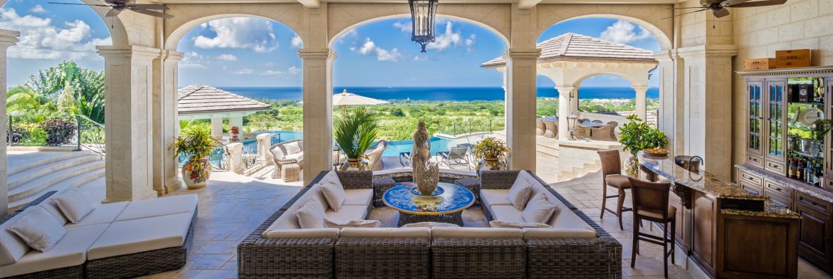 GH Construction Co. Ltd. example of work showing an outdoor sitting area looking through arches with the ocean in the distance.