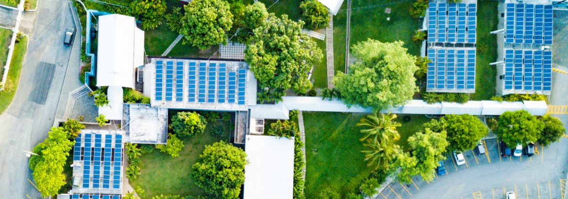 Isratech Jamaica IES Solar System Project aerial view showing buildings with solar panels on rooftops.